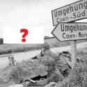 Sur cette célèbre photo prise le 7 juin 1944, les lance corporals A. Burton et L. Barnett tiennent fermement leur position. Mais en arrière-plan, vous rappelez vous ce qui se trouve de l'autre côté de la route ?